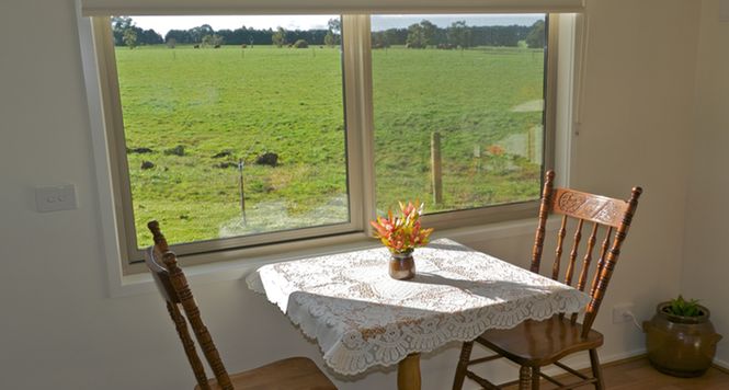 Sit in the sun and enjoy views of the farm at Little Lake Cottage